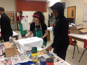 Ivana assisting student at Norristown High School with screen printing a t shirt
