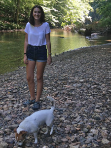 photo of girl and a dog at creek
