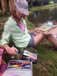 photo of Nanci Hersh sketching pondside with watercolors