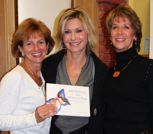 Photo of Ellen McVicker, Olivia Newton-John, Nanci Hersh with copy of book, Butterfly Kisses and Wishes on Wings